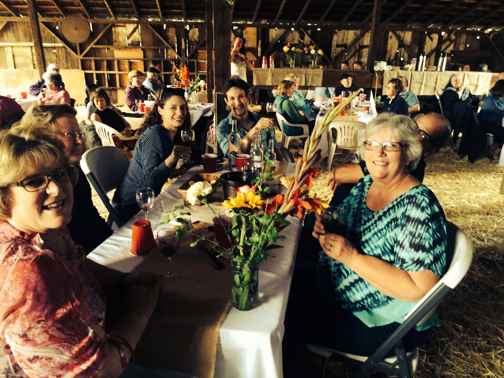 people with wine glasses and food at table