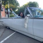 Happy woman in classic car