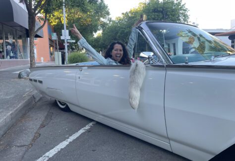 Happy woman in classic car