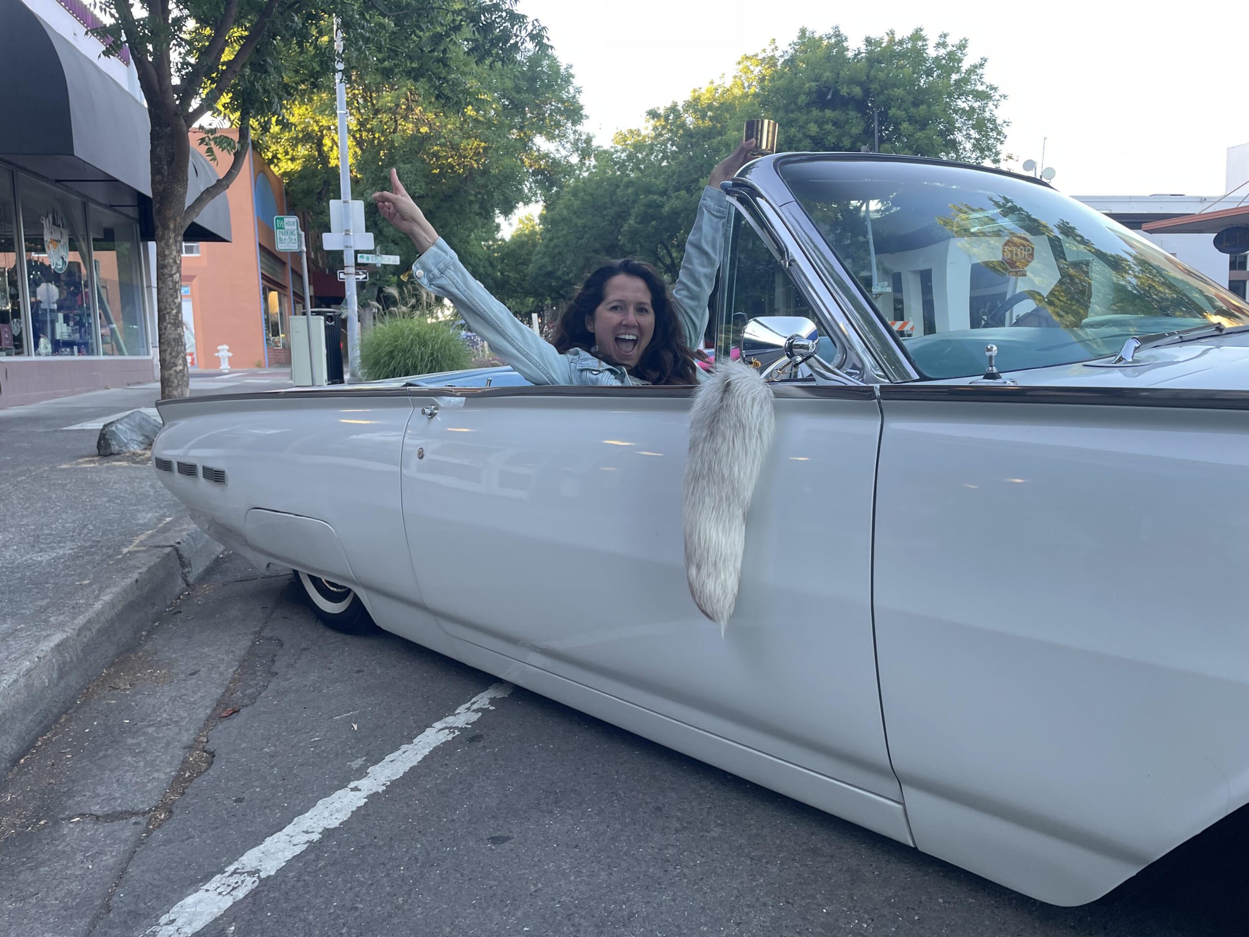 Happy woman in classic car